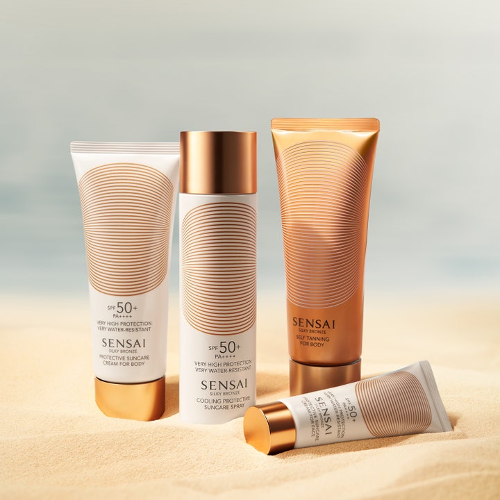 Sensai Silky Bronze Protective Cream Face 50 ml premium solkräm ansikte i vit tub med guldkork liggande på sand.