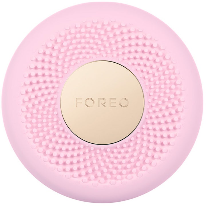 Foreo UFO ansiktsmaskapparat för hudvård i rosa silikon med en knottrig yta och central cirkel i guld