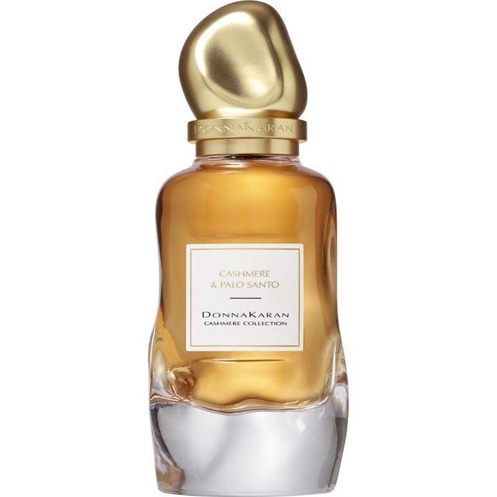 DKNY Cashmere Collection Palo Santo 100 ml Eau de Parfum med bärnstensfärgad vätska i vågig glasflaska med guldlock