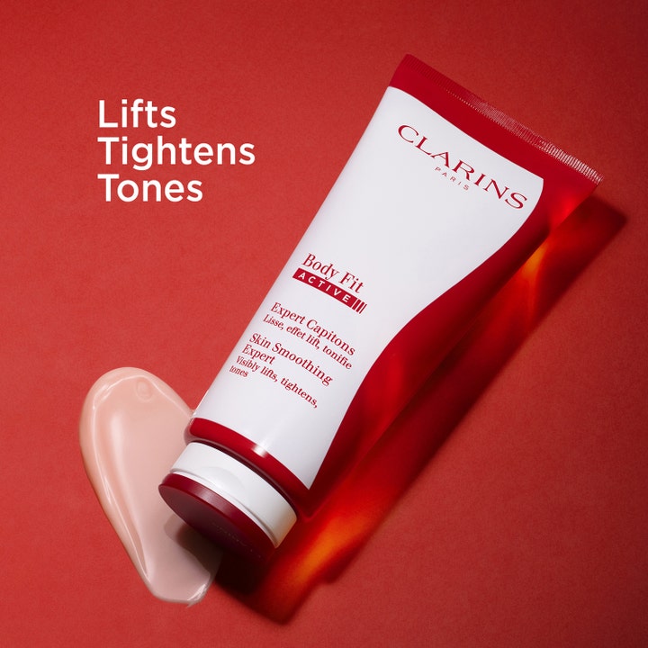 Clarins Body Fit Active 200 ml cellulitreducering med aktiv formula och ljusrosa kräm intill texten Lifts Tightens Tones