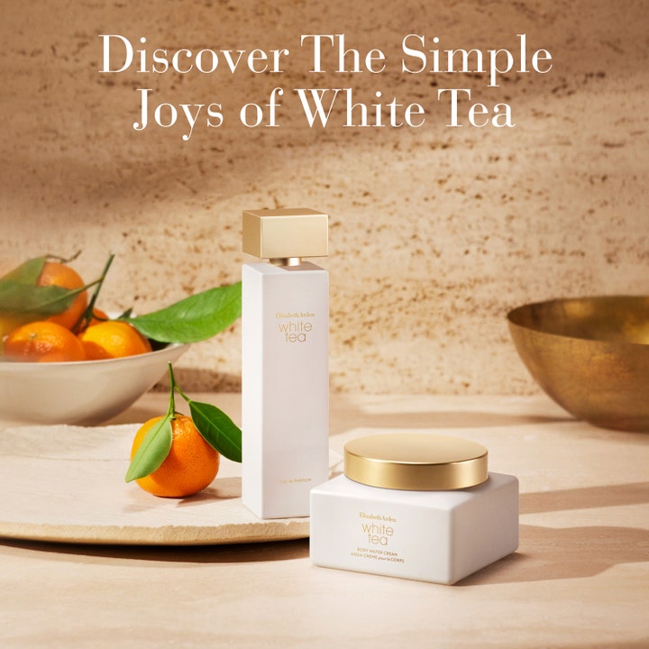 Elizabeth Arden White Tea Body Cream 225 ml återfuktande kroppskräm i vit burk med guldlock bredvid färska mandariner.