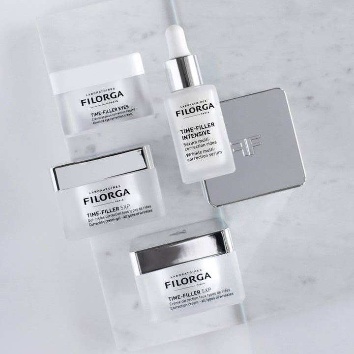 Filorga Time-Filler 5 XP 50 ml antiåldrande ansiktsbehandling i glasburk bredvid serum och ögonkräm