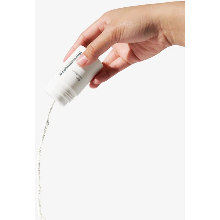 Dermalogica Daily Microfoliant peeling ansikte vitt pulver som hälls ur en vit flaska för ökad lyster.