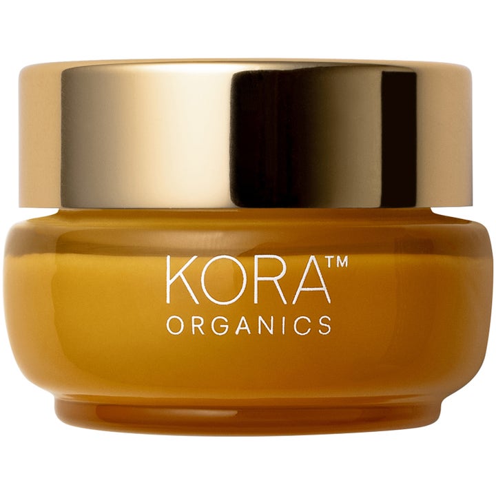 KORA Organics återfuktande ansiktskräm med ekologisk gurkmeja 50ml i bärnstensfärgad glasburk med ett glänsande guldlock.