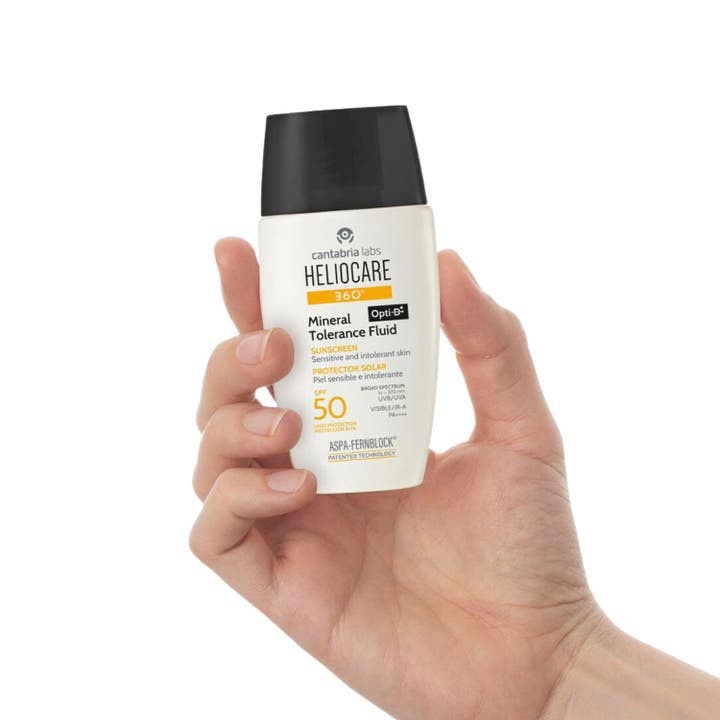 Heliocare Mineral Tolerance Fluid 50 ml bredspektrum solskydd känslig hud i vit ytterkartong med orange text.