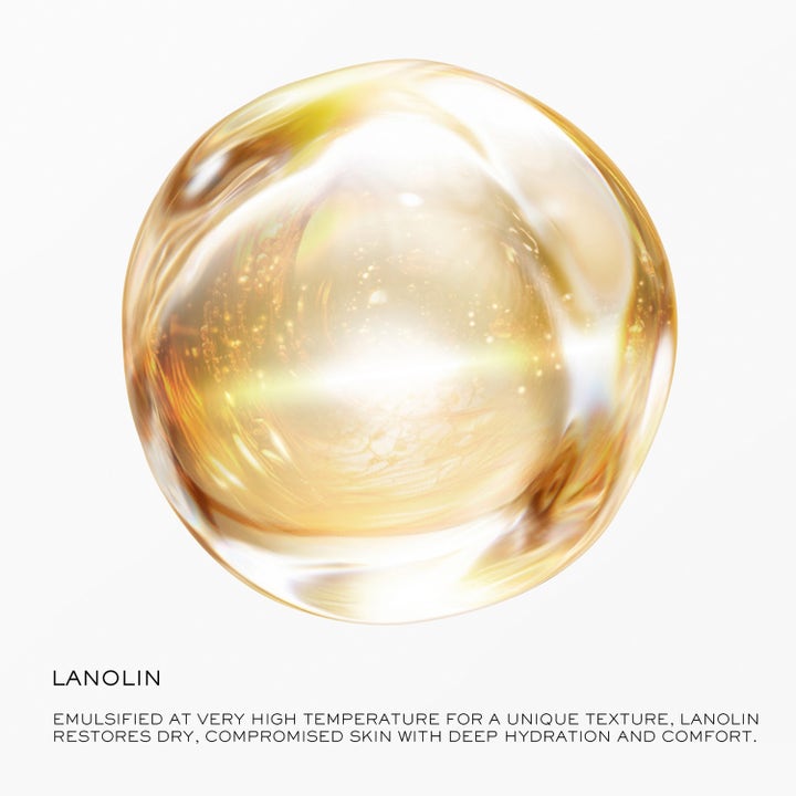 Lancôme Nutrix Visage 50 ml dagkräm med lanolin som ger djup återfuktning visas som en glimrande gyllene droppe.