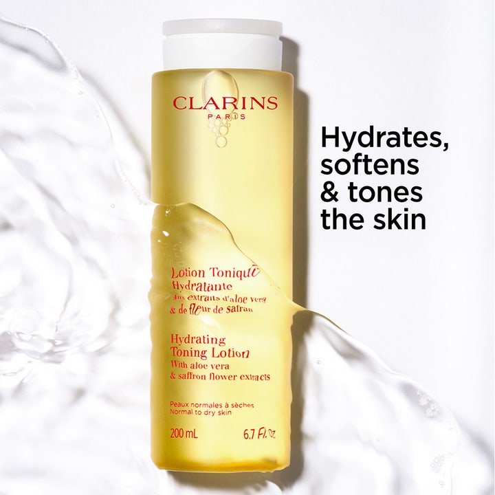 Clarins Hydrating Toning Lotion 400 ml återfuktande toner i gul flaska med texten hydrates softens and tones the skin.