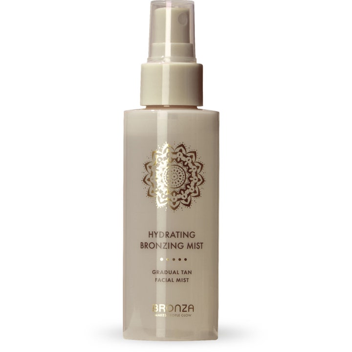 Bronza Hydrating Bronzing Mist ansiktsspray för glödande hy i vit flaska med guldig mandala och genomskinligt lock