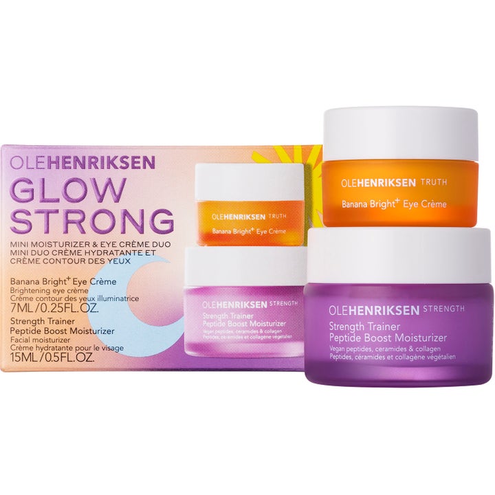Ole Henriksen Glow Strong 22 ml hudvårdskit med lystergivande ögonkräm och ansiktskräm i orange och lila burkar.