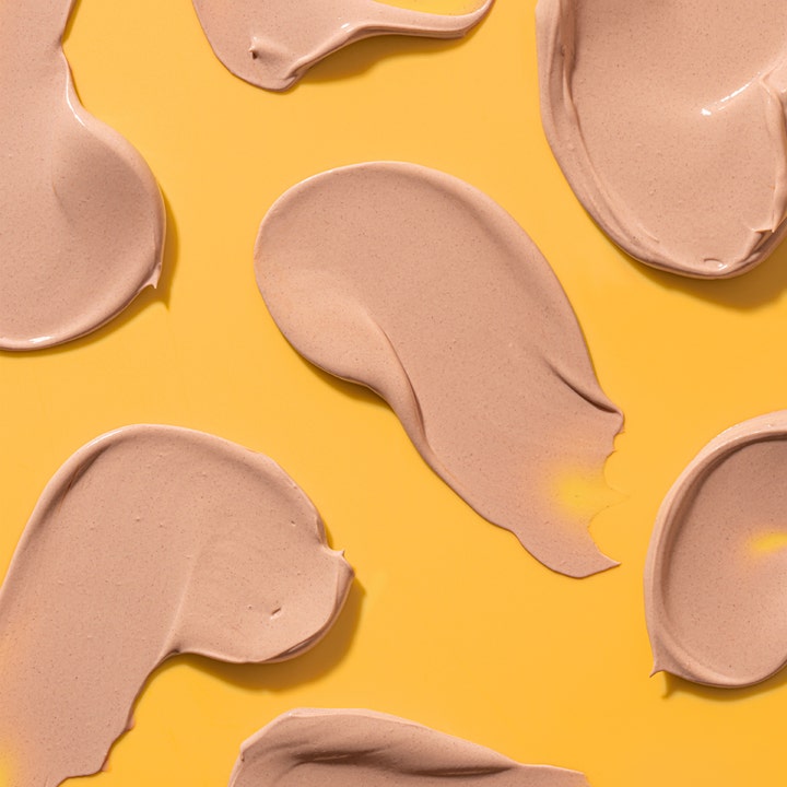 Bondi Sands SPF50+ Hydrating Tinted Face Lotion 75 ml fuktlotion ansikte med krämiga tonade swatches på gul bakgrund.