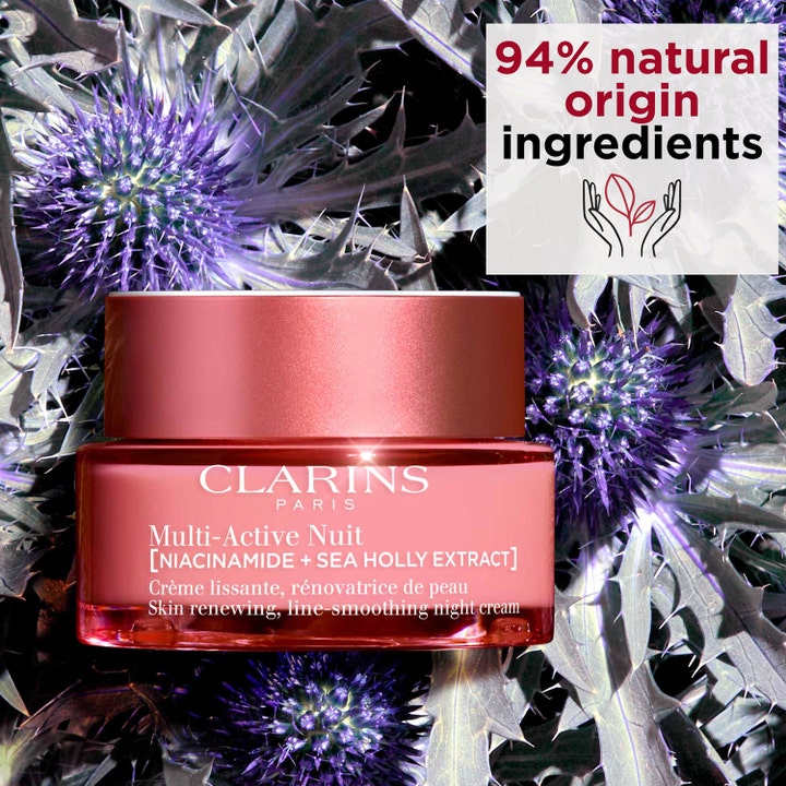 Clarins Multi-Active Nuit 50 ml nattkräm i rosa glasburk med 94% naturligt innehåll placerad bland lila tistlar