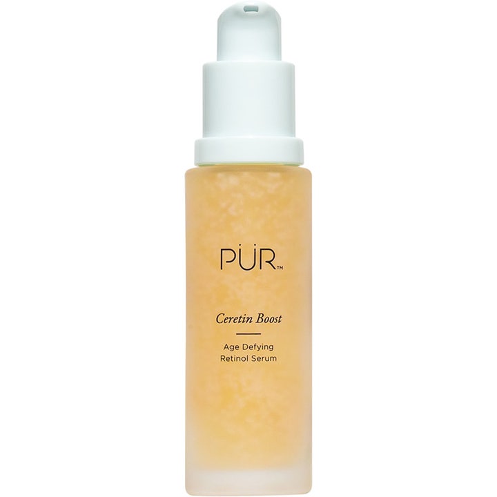 PÜR Ceretin Boost Age Defying Retinol Serum anti-age i en frostad glasflaska med vit pump och kornig orange formula.