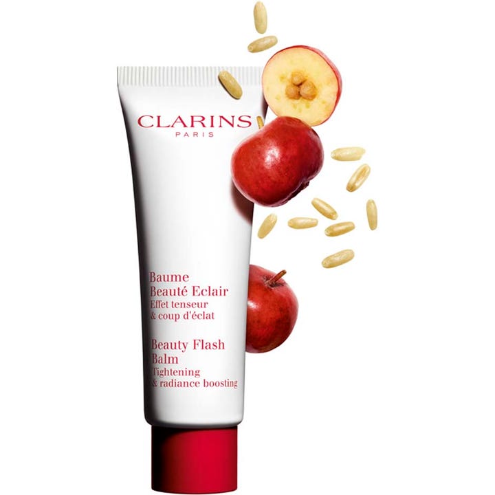 Clarins Beauty Flash Balm 50 ml lystergivande glowkräm i vit tub med rött lock omgiven av röda bär och havre