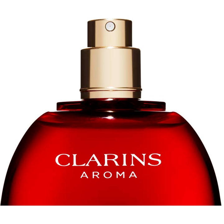 Clarins Eau Dynamisante Deodorant Spray 100 ml deospray ger fräschör i röd glasflaska med guldfärgat spraymunstycke