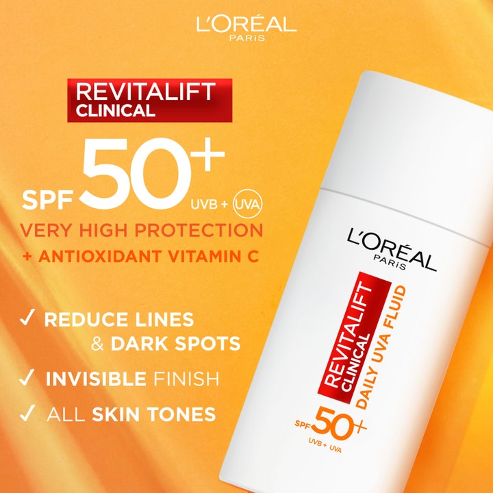 L'Oréal Paris Revitalift Clinical Daily UVA Fluid 50 ml solskydd med SPF 50 och vitamin C på orange bakgrund