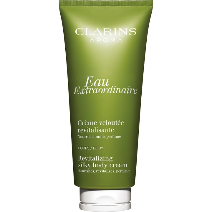 Clarins Eau Extraordinaire Revitalizing Silky Body Cream fuktkräm kropp i mossgrön tub, en lyxig doftkräm för mjuk hud.