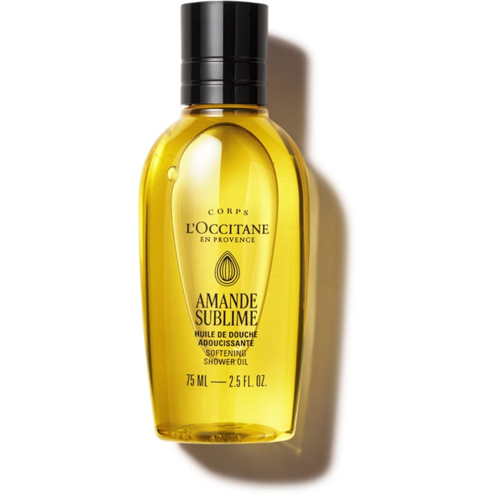 L'Occitane Amande Sublime 75 ml mjukgörande duscholja i genomskinlig flaska med guldgul vätska och svart lock.