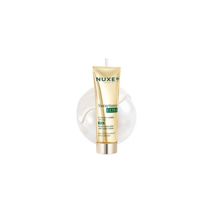 Nuxe Nuxuriance Ultra 50 ml dagkräm mot fläckar med SPF 30 och niacinamide i guldtub framför en krämig klick