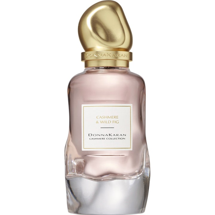 DKNY Cashmere Collection Wild Fig 100 ml Eau de Parfum i vågig glasflaska med rosa vätska och skulpturalt guldlock