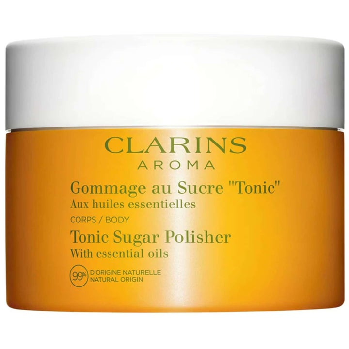 Clarins Aroma Tonic Sugar Polisher 250 ml toniserande kroppsskrubb som ger mjuk hud i orange burk med vitt lock