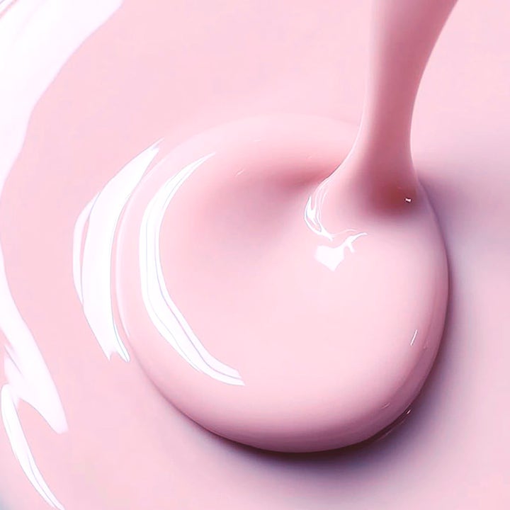 MANTLE The Miracle Fluid 250 ml återfuktande serum med en ljusrosa krämig och silkeslen flytande textur som ger lyster.
