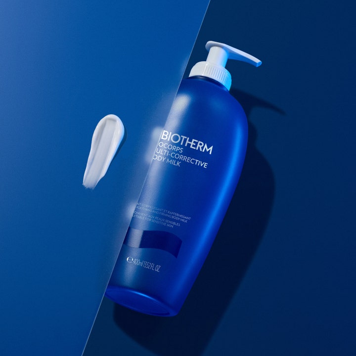 Biotherm Biocorps Body Milk 400 ml fast-stärkande kroppslotion för torr hud med krämig vit textur bredvid blå flaska.