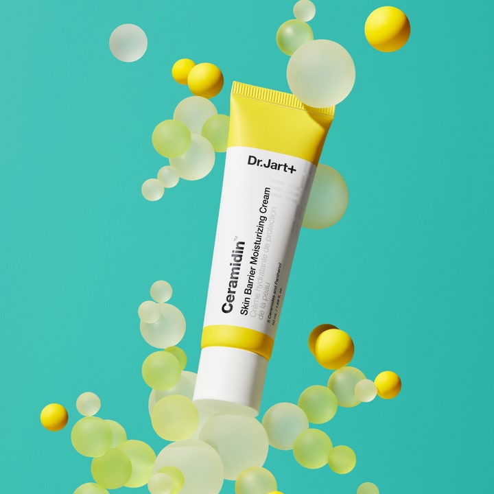Dr.Jart+ Ceramidin Skin Barrier Moisturizing Cream 50 ml ceramidin kräm i gul tub omgiven av svävande gula sfärer.