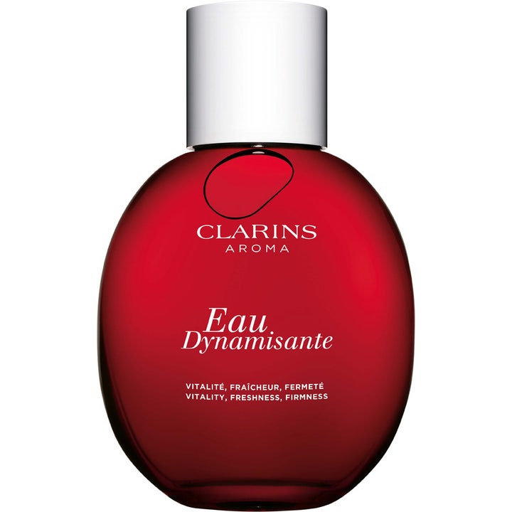 Clarins Eau Dynamisante 50 ml aromatisk kroppsspray som ger en fräsch parfym i rund röd glasflaska med silverlock