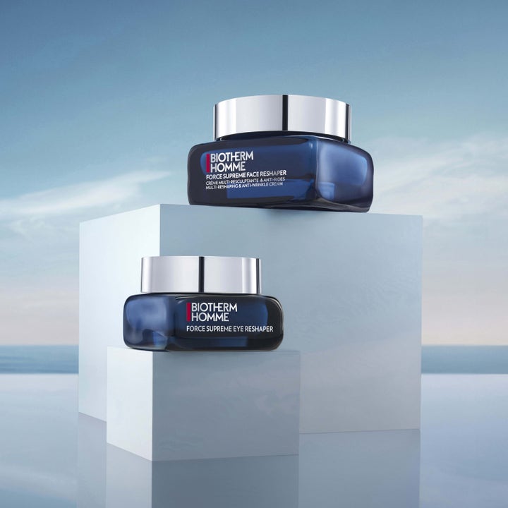 Biotherm Force Supreme Eye Reshaper 20 ml uppstramande ögonkräm i blå glasburk på vita podier mot en ljusblå bakgrund.