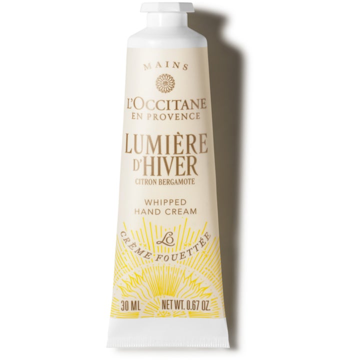 L'Occitane Lumière d'Hiver 30 ml mjukgörande vispad handkräm i beige tub med gul solgrafik och vitt skruvlock.
