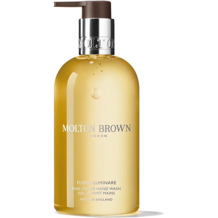 Molton Brown Flora Luminare 300 ml lyxig handtvål blommig parfym i klar flaska med guldgul gel och silverdetaljer.