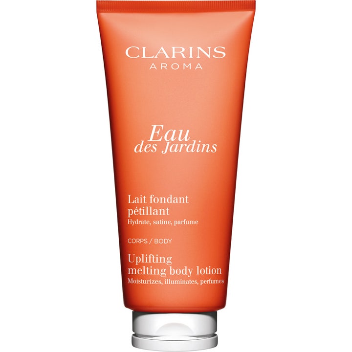 Clarins Eau des Jardins Uplifting Melting Body Lotion lyxig kroppslotion för torr hud i orange tub med vitt lock.