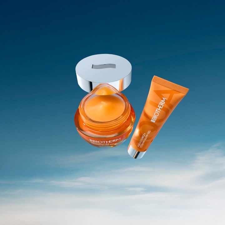 Biotherm Aquasource Vitamin Glow Gel 30 ml lystergivande ansiktskräm i orange glasburk och tub mot en blå himmel