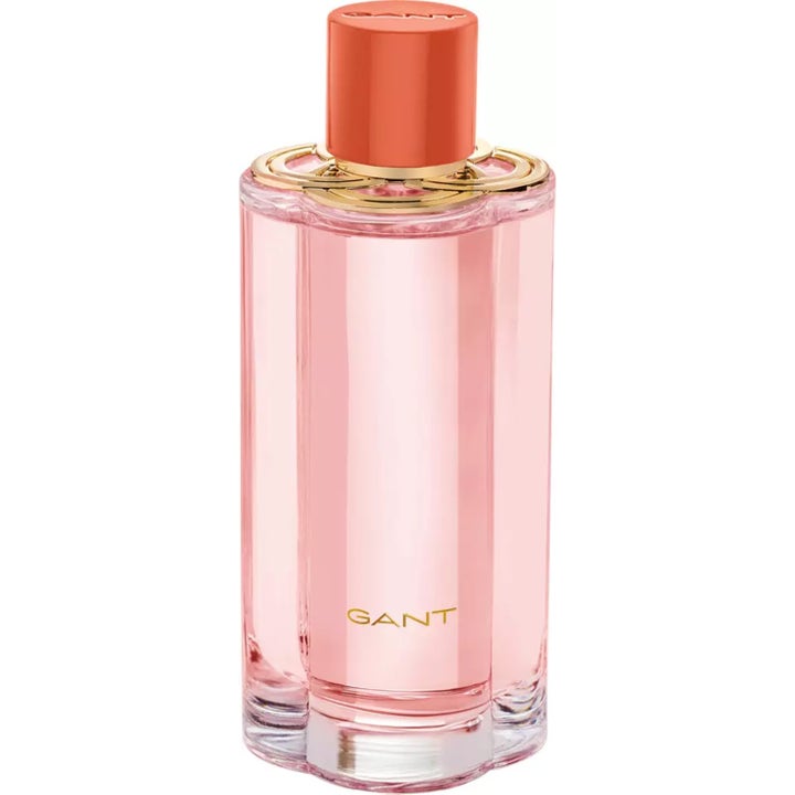 GANT Bloom Bay 100 ml parfym i elegant cylinderformad glasflaska med rosa vätska, gulddetaljer och korallfärgad kork