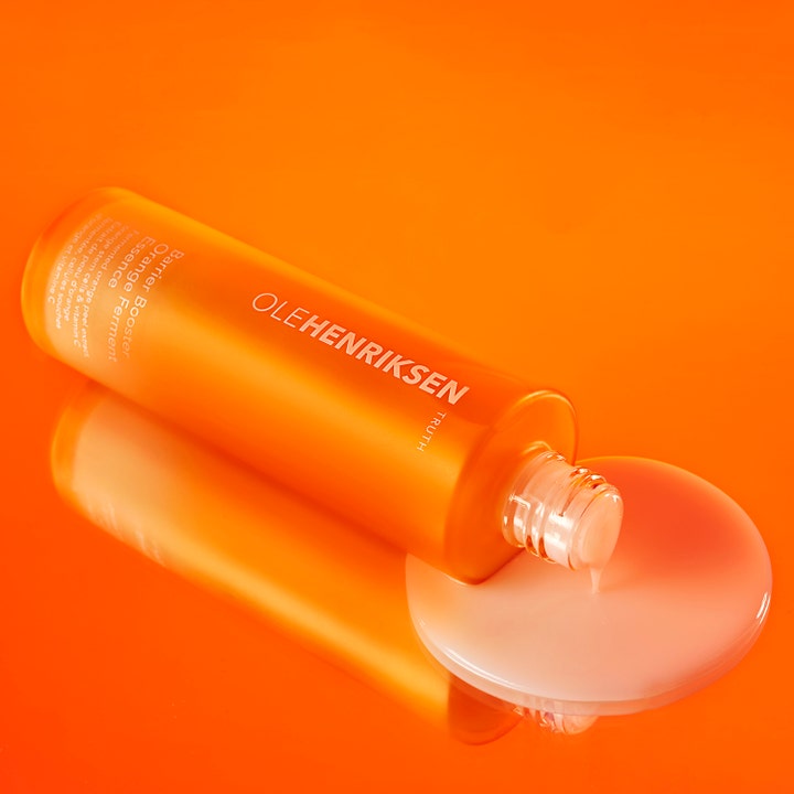Ole Henriksen Truth Barrier Booster Orange Ferment Essence 118 ml återfuktande essence med mjölkig textur på orange yta