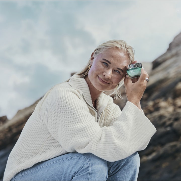 Biotherm Aquasource Hyalu Plump 30 ml återfuktande ansiktsgel för fukt i grön glasburk som hålls av en kvinna utomhus