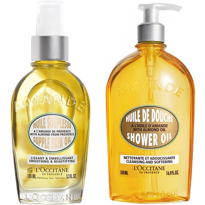 L'Occitane Amande 100 ml och 500 ml mjukgörande kroppsolja i genomskinliga flaskor med gyllene innehåll, spray och pump.