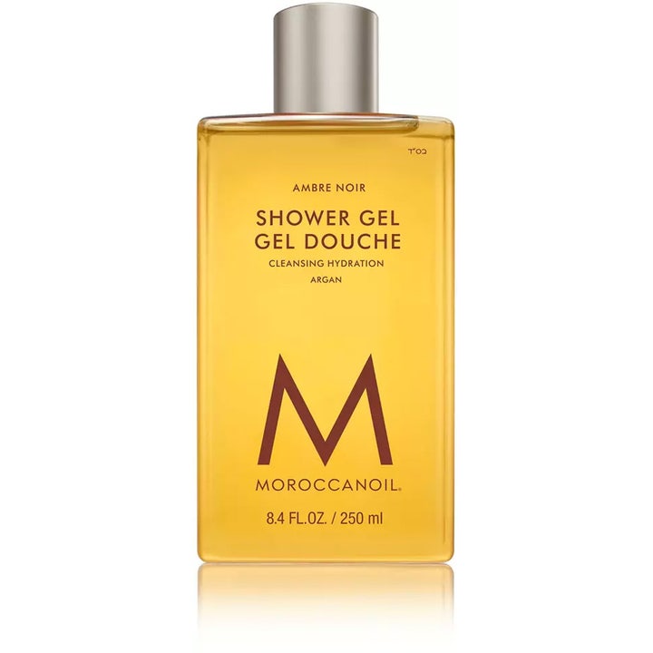 Moroccanoil Ambre Noir 250 ml djupfuktande duschgel i genomskinlig flaska med bärnstensfärgad gel och silverlock.