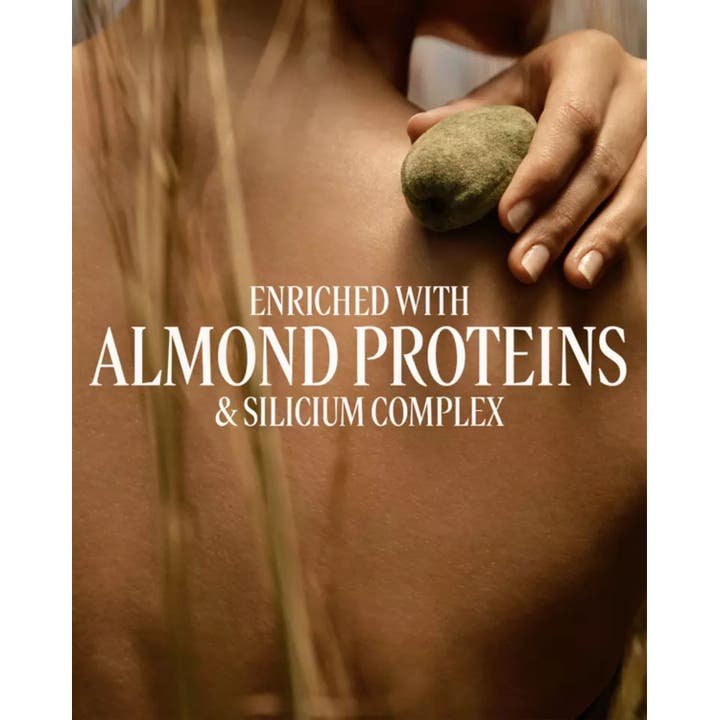 L'Occitane en Provence Almond Milk Concentrate 200 ml fast mandelkräm med mandelprotein och en hand på bar rygg
