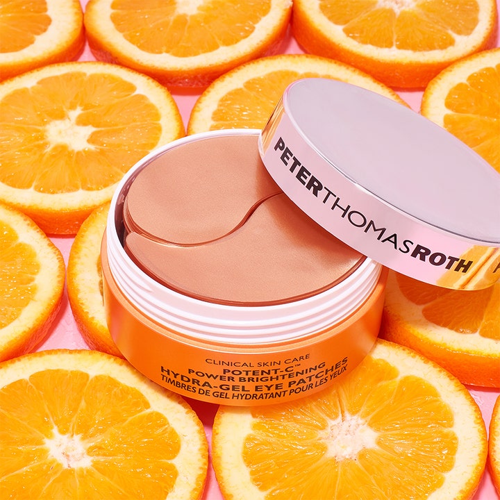 Peter Thomas Roth Potent-C Eye Patches 90 g ögonmask mot mörka ringar i burk omgiven av färska apelsiner