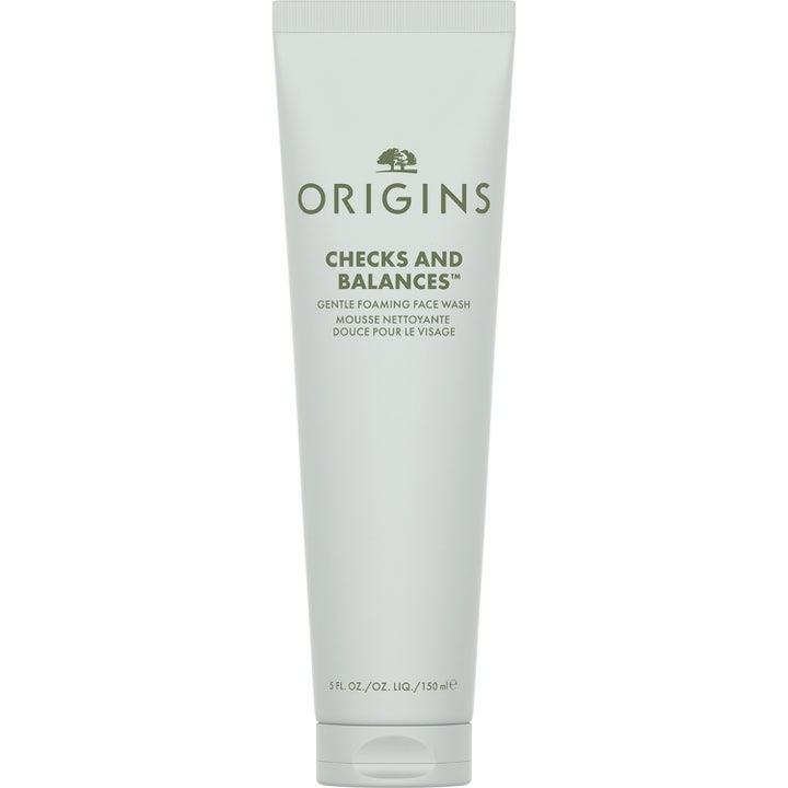 Origins Checks and Balances 150 ml skonsam löddrande ansiktsrengöring i en vit tub med grön text och praktiskt lock.