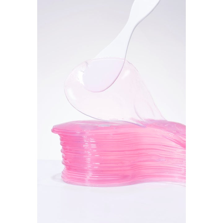 COSRX The Peptide Collagen Hydrogel Eye patch 60 st K-beauty ögonmask med rosa gelplåster som lyfts av en spatel