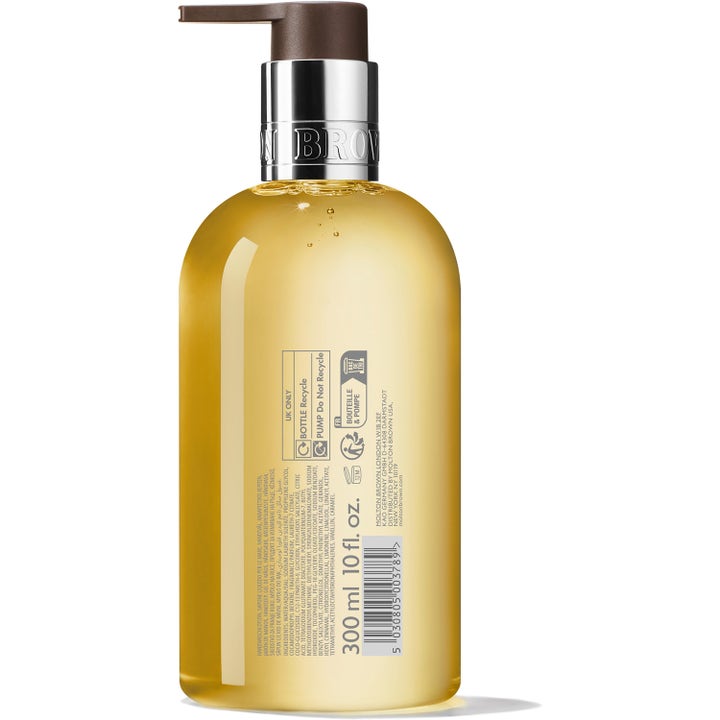 Molton Brown Flora Luminare Fine Liquid Hand Wash 300 ml lyxig handtvål i klar flaska med gul vätska och baksidans etikett.