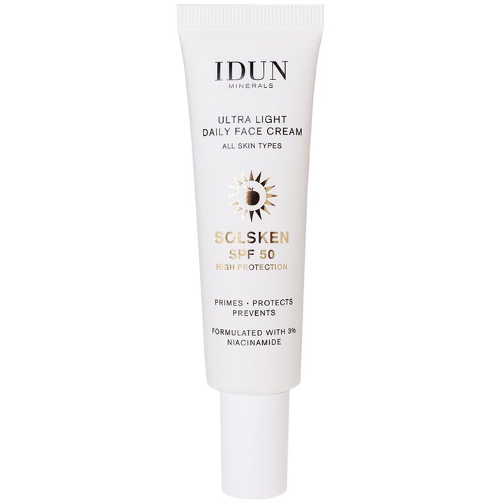IDUN Minerals Solsken SPF 50 ansiktskräm med 3% niacinamid i vit tub med guldiga detaljer som skyddar och stärker huden.