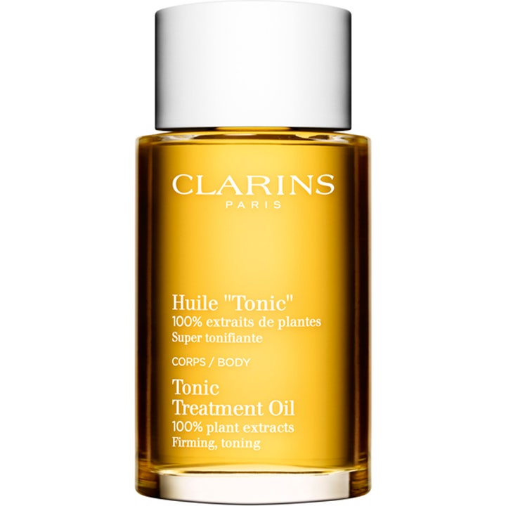 Clarins Tonic Treatment Oil 100ml kroppsolja för torr och fast hud i glasflaska med gyllene olja och vitt lock.