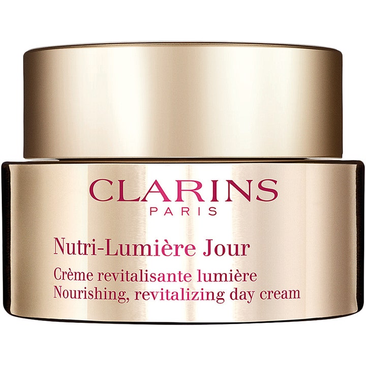 Clarins Nutri-Lumière Jour närande dagkräm ger lyster i en exklusiv guldfärgad glasburk med matchande guldlock