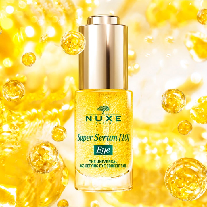 Nuxe Super Serum [10] Eye 15 ml anti-rynk ögonserum i glasflaska med guldlock och gyllene mikropärlor bland bubblor