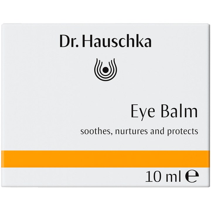 Dr. Hauschka Eye Balm 10 ml ögonbalsam för känslig hud ger skydd i en vit ytterförpackning med orange detaljer.