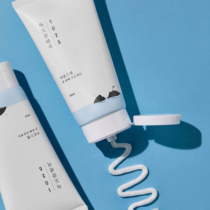 Round Lab 1025 Dokdo Cleanser 150 ml hypoallergen ansiktsrengöring i tub med krämig vit textur på blå bakgrund