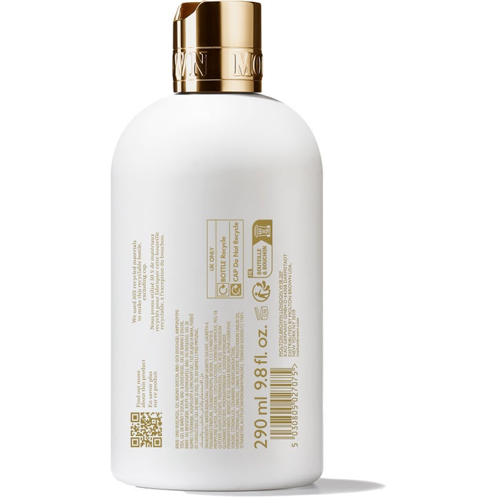 Molton Brown Milk Musk badgel 300 ml doftande duschtvål i vit flaska med guldkork som visar baksidan